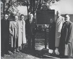 Hazel Chisholm Mathews standing beside a newly erected plaque. .